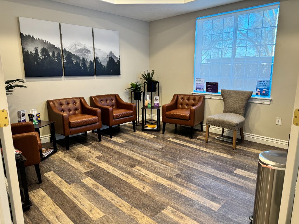 JRCU patient lounge with leather chairs and mountain artwork